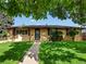 Charming brick home with a well-maintained lawn and mature trees at 3018 S Depew St, Denver, CO 80227