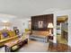 Spacious living room with vintage sofas and a connecting view to the kitchen and dining area at 3018 S Depew St, Denver, CO 80227