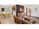 Spacious living room featuring retro-styled sofas, wood paneling, and adjacent dining area at 3018 S Depew St, Denver, CO 80227