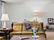 Bright living room featuring vintage decor, ample natural light, and a cozy atmosphere at 3018 S Depew St, Denver, CO 80227