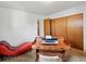 Bright office area with a vintage wooden desk and a unique lounge chair at 3018 S Depew St, Denver, CO 80227