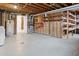 Unfinished basement area with exposed ceiling, shelving, and utility access at 3097 E Caley Ave, Centennial, CO 80121