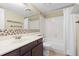 Bathroom with vanity, mirror, shower, and tiled wall detail at 2880 S Locust St # 708S, Denver, CO 80222
