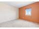 Bright bedroom featuring neutral carpet, a window, and an accent wall at 2880 S Locust St # 708S, Denver, CO 80222