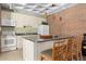 This kitchen features an island with bar stool seating, a refrigerator, stove, microwave, and a sink at 2880 S Locust St # 708S, Denver, CO 80222