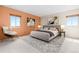 Staged main bedroom featuring large windows, contemporary decor, and carpet at 2880 S Locust St # 708S, Denver, CO 80222