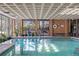 A large indoor pool area complete with lounge chairs, a life preserver and many potted plants at 2880 S Locust St # 708S, Denver, CO 80222