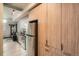 Modern studio kitchen with stainless steel appliances and wood cabinets at 603 Inca St # 528, Denver, CO 80204