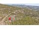Aerial view of house nestled among trees, a great place to enjoy peace and quiet at 1189 Lodgepole Dr, Evergreen, CO 80439