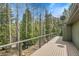 Wooden deck shows views of trees and sky for relaxation and enjoying the outdoors at 1189 Lodgepole Dr, Evergreen, CO 80439