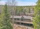 Aerial view of the house with a nice wooden deck for the best views of nature and enjoying the outdoors at 1189 Lodgepole Dr, Evergreen, CO 80439