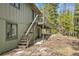 Exterior with stairs leading to upper deck shows the home is great for entertaining and enjoying the outdoors at 1189 Lodgepole Dr, Evergreen, CO 80439