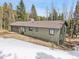 Exterior with snow, shows house is great for relaxing and enjoying peace and quiet at 1189 Lodgepole Dr, Evergreen, CO 80439