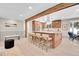 Bright kitchen features a spacious island with bar seating, stainless steel appliances, and wood beam accents at 1189 Lodgepole Dr, Evergreen, CO 80439