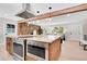 Beautiful kitchen featuring granite counters, stainless appliances, wooden accents and open layout at 1189 Lodgepole Dr, Evergreen, CO 80439