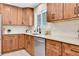 Well-lit kitchen with stainless steel appliances, granite countertops, and wooden cabinetry at 1189 Lodgepole Dr, Evergreen, CO 80439