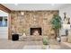 Living room features gorgeous rock fireplace, mantel and stone hearth at 1189 Lodgepole Dr, Evergreen, CO 80439