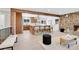 Open-concept living room and kitchen with stone fireplace, wood accents, and hardwood floors at 1189 Lodgepole Dr, Evergreen, CO 80439