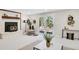 Inviting living room featuring a fireplace, outside access, stylish decor, and neutral paint at 1189 Lodgepole Dr, Evergreen, CO 80439
