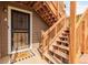 Close up of the front door and wooden stairs leading to the unit entrance at 2296 S Pitkin Way # A, Aurora, CO 80013