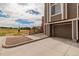 Exterior of the home with a garage, concrete driveway, and a partial view of the surrounding landscape at 2296 S Pitkin Way # A, Aurora, CO 80013