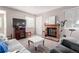 Relaxing living room space featuring a brick fireplace and ample natural light from the windows at 2296 S Pitkin Way # A, Aurora, CO 80013