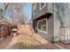 A partial view of the backyard with a brick patio, a lawn, and a grill ready for outdoor entertaining at 9699 W 99Th Ave, Broomfield, CO 80021