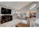 Spacious living room with a large screen tv, neutral color palette, and seamless flow into other living spaces at 9699 W 99Th Ave, Broomfield, CO 80021