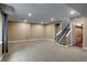 Finished basement featuring carpeted floor, recessed lighting, and a staircase leading upstairs, creating comfortable extra space at 602 Mathews Way, Erie, CO 80516