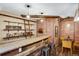 Finished basement with a custom bar, brick wall accent, and cozy seating area at 602 Mathews Way, Erie, CO 80516