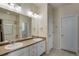 Spacious bathroom with a double vanity, white cabinetry, and separate shower/tub area at 602 Mathews Way, Erie, CO 80516