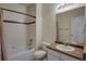 Clean and functional bathroom with a tiled shower-tub, toilet, and vanity sink with a mirror for personal hygiene at 602 Mathews Way, Erie, CO 80516