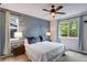 Stylish bedroom with a modern accent wall, neutral decor, and ample natural light at 602 Mathews Way, Erie, CO 80516