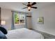 Cozy bedroom features a ceiling fan, and a bright window with neighborhood views at 602 Mathews Way, Erie, CO 80516