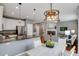 Open concept dining area with modern lighting that adjoins living room and kitchen at 602 Mathews Way, Erie, CO 80516