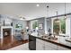 Open kitchen and living area featuring modern appliances and comfortable seating arrangement at 602 Mathews Way, Erie, CO 80516