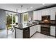 Modern kitchen featuring granite countertops, stainless steel appliances, and dining area at 602 Mathews Way, Erie, CO 80516