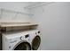 Convenient laundry room includes a washer and dryer and ample shelving for storage solutions at 602 Mathews Way, Erie, CO 80516