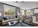 Bright living room with ample natural light, comfortable seating, and seamless flow to dining area at 602 Mathews Way, Erie, CO 80516
