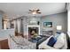 Inviting living room featuring a fireplace, ceiling fan, and comfortable seating at 602 Mathews Way, Erie, CO 80516