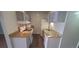 Galley kitchen with white cabinets and granite counters at 10792 E Exposition Ave Ave # 254, Aurora, CO 80012