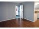Living room with wood floors, gray walls, and view of the kitchen at 10792 E Exposition Ave Ave # 254, Aurora, CO 80012