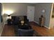 Spacious living room with wood floors and view of the entry door at 10792 E Exposition Ave Ave # 254, Aurora, CO 80012