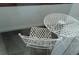 Small patio with white metal table and chair at 10792 E Exposition Ave Ave # 254, Aurora, CO 80012