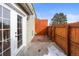 Cozy backyard with a wooden fence, concrete patio, and access from the French doors at 5721 W 92Nd Ave # 52, Westminster, CO 80031