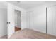 Bright bedroom with neutral carpet, white walls, and closet space at 5721 W 92Nd Ave # 52, Westminster, CO 80031
