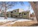 Charming two-story townhome with a walkway and snowy front yard, surrounded by mature trees at 5721 W 92Nd Ave # 52, Westminster, CO 80031