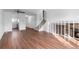 Bright living room featuring a fireplace, staircase, and wood-look flooring, creating a cozy and inviting space at 5721 W 92Nd Ave # 52, Westminster, CO 80031