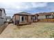 Spacious backyard with grass, gravel, and a back deck at 7809 Bandit Dr, Castle Rock, CO 80108