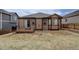 Spacious backyard with grass, gravel, and a back deck at 7809 Bandit Dr, Castle Rock, CO 80108